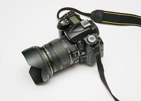 Black Dslr Camera on White Surface
